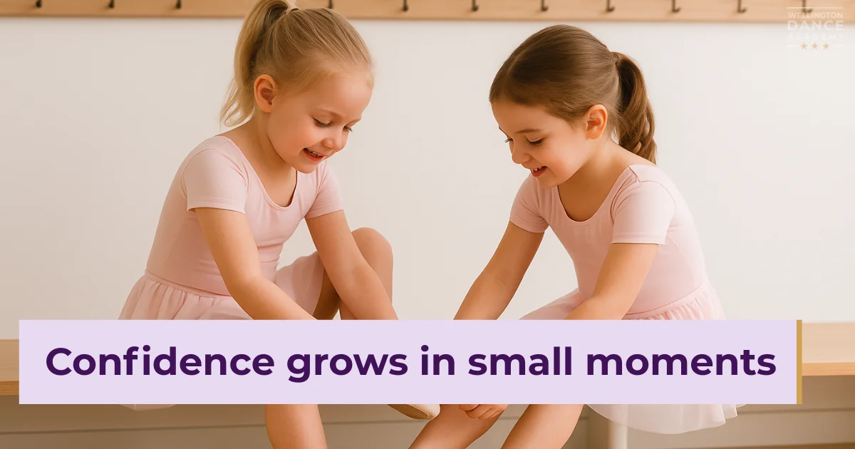 Two ballet girls helping each other put on shoes before class.